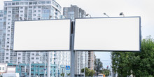 Two Big White Empty Billboards On Pole At City Street Commercial Advertising Concept