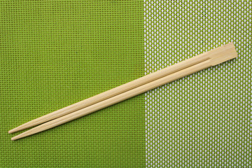 Chopsticks for oriental or asian food on a green background