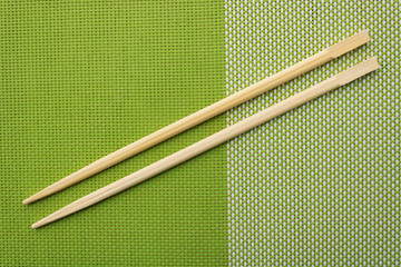 Chopsticks for oriental or asian food on a green background