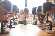 © Tetra Images - Students using microscopes in science class