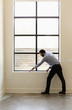 © Tetra Images - Mixed race realtor measuring window in new house