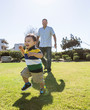 © Tetra Images - Hispanic father and son playing in park