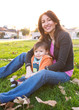 © Tetra Images - Hispanic mother sitting with son in park