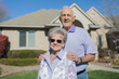 © Tetra Images - Older Caucasian couple smiling in yard