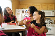 © Tetra Images - Laughing family sitting in kitchen