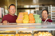 © Tetra Images - Hispanic bakers smiling in kitchen