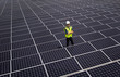 © Tetra Images - Caucasian technician smiling on solar panels
