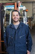 © Tetra Images - Hispanic worker smiling in warehouse