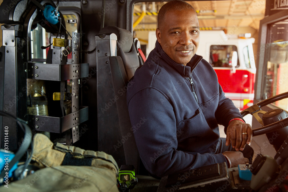 Portrait of fireman sitting in driver's seat of fire engine Stock Photo ...