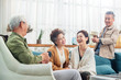 © View Stock - Happy old people sitting in the living room to chat over a cup of tea