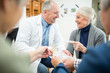 © Westend61 - Doctor playing jigsaw puzzle with group of seniors in retirement home