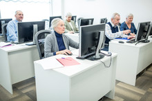 Active Seniors Attending Computer Course, Working On PC