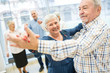 © Westend61 - Group of active senior attending dance course in retirement home