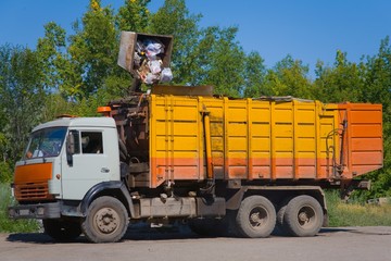 Heavy yellow garbage truck KAMAZ