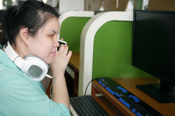 asian young blind person woman with headphone using smart phone with voice assistive technology for 
