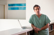 © SuperStock - Portrait of Hispanic Male doctor in his home taking a break from practicing Tele-medicine