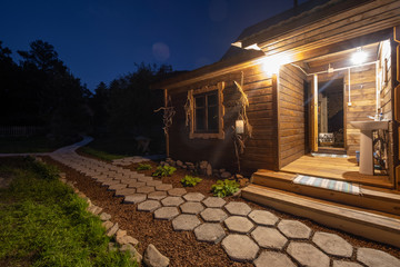 Wooden house with lights at night time in mountains hotel resort