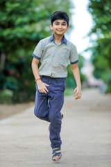 Indian school boy playing hop-scotch in playground