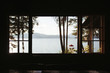 © Colson Struss - view of lake and mountains and dock sunny through the silhouette of a window