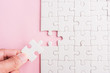 © sorapop - Top view flat lay of hand-holding last piece white paper jigsaw puzzle game last pieces put to place for solve problem complete mission, studio shot on a pink background, quiz calculation concept