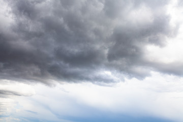 Wall Mural - gray rainy clouds in blue sky on summer day in rain