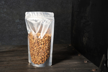 Sticker - peanut snack on a blank standing pouch mockup with transparent window