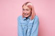 © RealPeopleStudio - Woman with pink dyed hair smiling looking shy at camera
