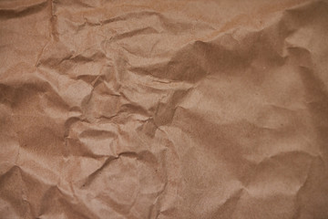 Background from crumpled craft paper. Background from brown paper. Crumpled mumag texture.
