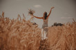 young girl in white in a wheat field