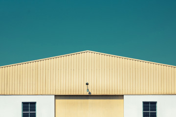 Poster - Yellow wharehouse facade. Closed storage building in an industrial park