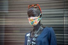 Closeup Of Fabric Mask On Mannequin In A Fashion Store Showroom During The Covid-19 Pandemic