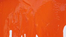 Bright Orange Paint Flows Down From White Canvas, Abstract Background, Art Minimalism, Painting Background With Colored Pigment On Textured Paper