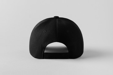 Black baseball cap mockup on a grey background, back view.