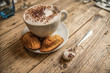 perfect rustic country wooden table cappuccino coffee latte art and madeleine cakes