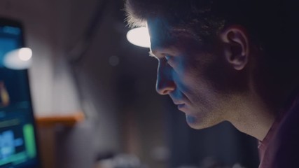 Man working at computer in home office at night