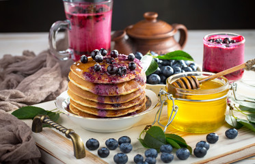 Pancakes with blueberries, breakfast on an old background