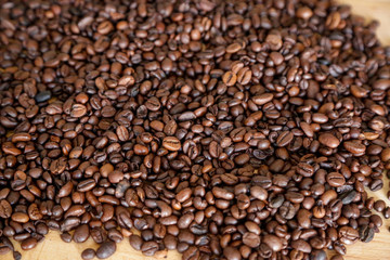 Wall Mural - Coffee grains on wooden table, with natural light