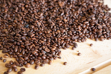 Wall Mural - Coffee grains on wooden table, with natural light