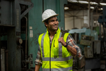 Engineers operating a machine in factory