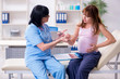 © Elnur - Young pregnant woman visiting experienced doctor gynecologist