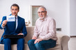 © Elnur - Young male lawyer visiting old man in testament concept