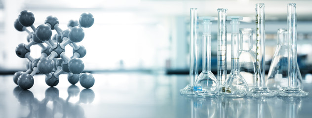 Wall Mural - glass flask and cylinder in chemistry laboratory and molecular structure education technology banner