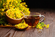 Herbal Tea Of Hypericum Perforatum Or St Johns Wort Medicinal Herb With Fresh Flowers In Wooden Bowl And Spoon