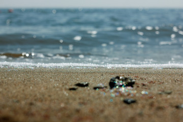 Close-up of sand on the beach and water of the Yarovoe salt lake (Altai Territory).