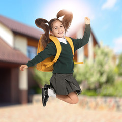 Poster - Happy girl jumping near house. School holidays