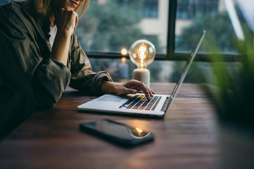 Young woman working with a laptop. Female freelancer connecting to internet via computer. Businesswoman at work