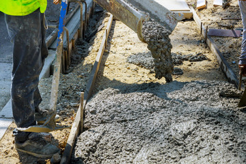 Canvas Print - Construction worker pour cement for sidewalk in truck mixer pouring concrete cement for construction sidewalk