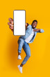 © Prostock-studio - Excited african guy dancing with modern smartphone