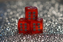 Close Up Of Three Red Playing Dice 6 6 6 On A Glittering  Silver Bokeh Background