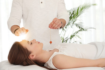 Wall Mural - Young woman during crystal healing session in therapy room